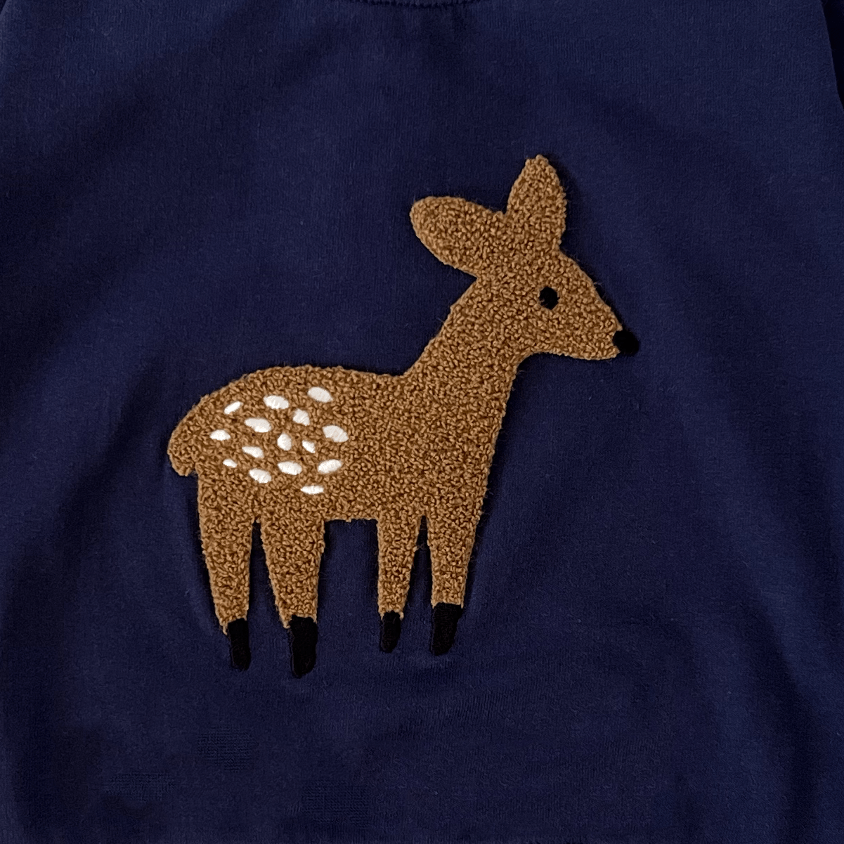 Navy blue sweatshirt with a deer design on a white background