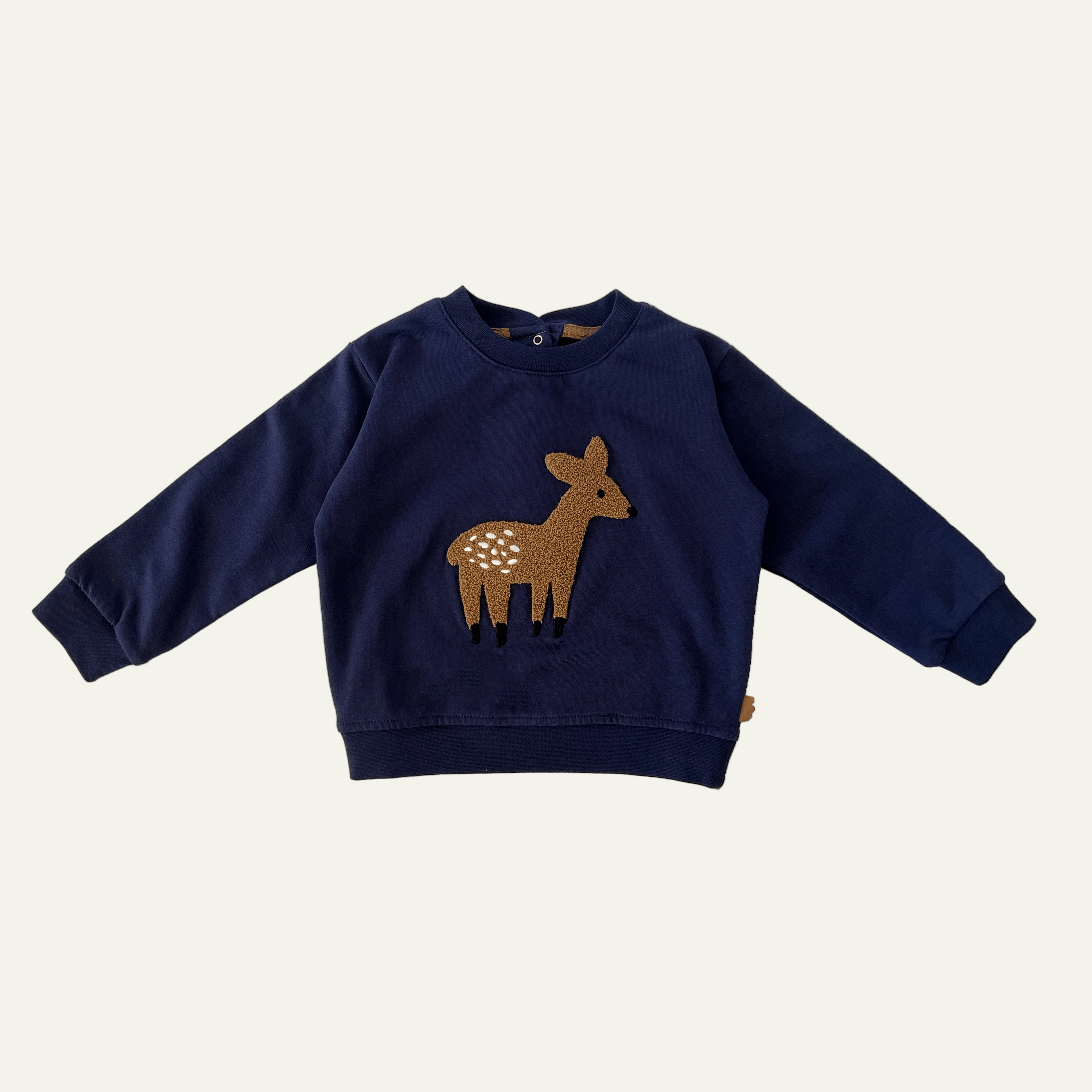 Navy blue sweater with a deer design on a white background